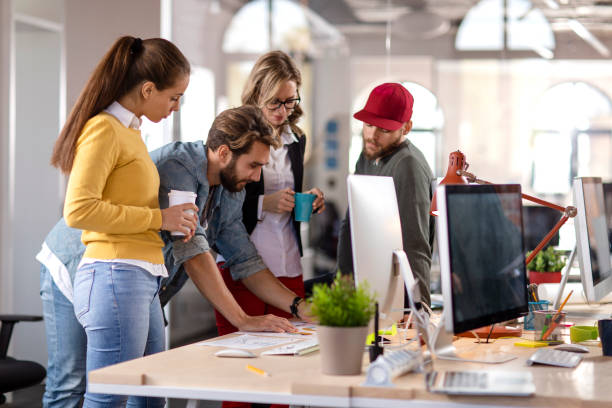 Four colleagues working together in the office